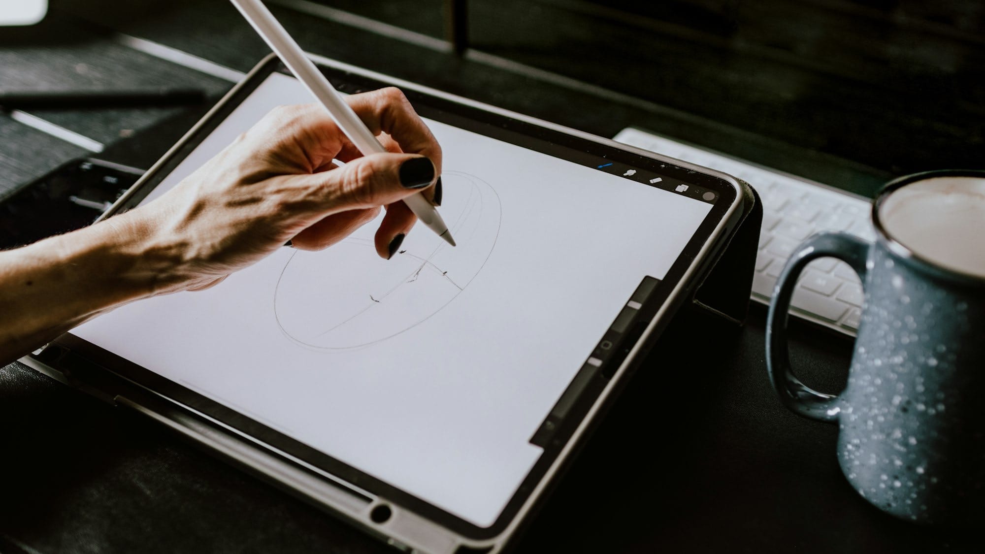 person holding white ipad with black case